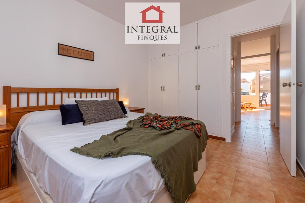 Habitació amb cama de matrimoni i armaris empotrats.