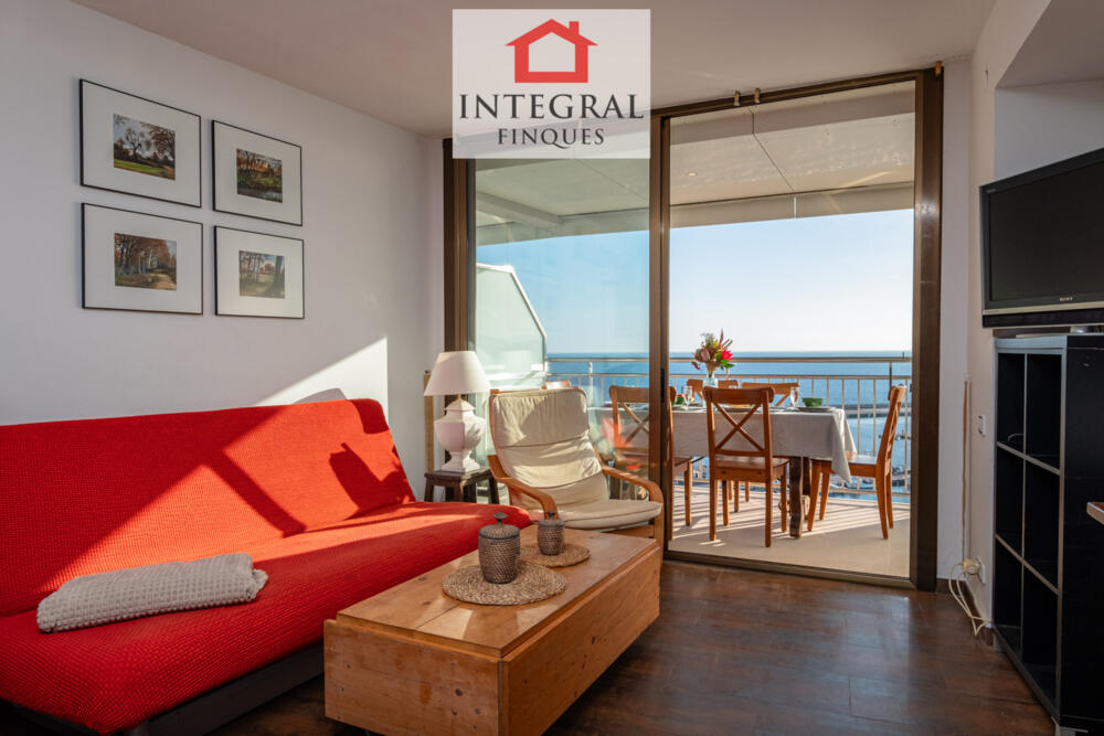 Sala d'estar amb televisió i vistes a la Platja Gran de Palamós.