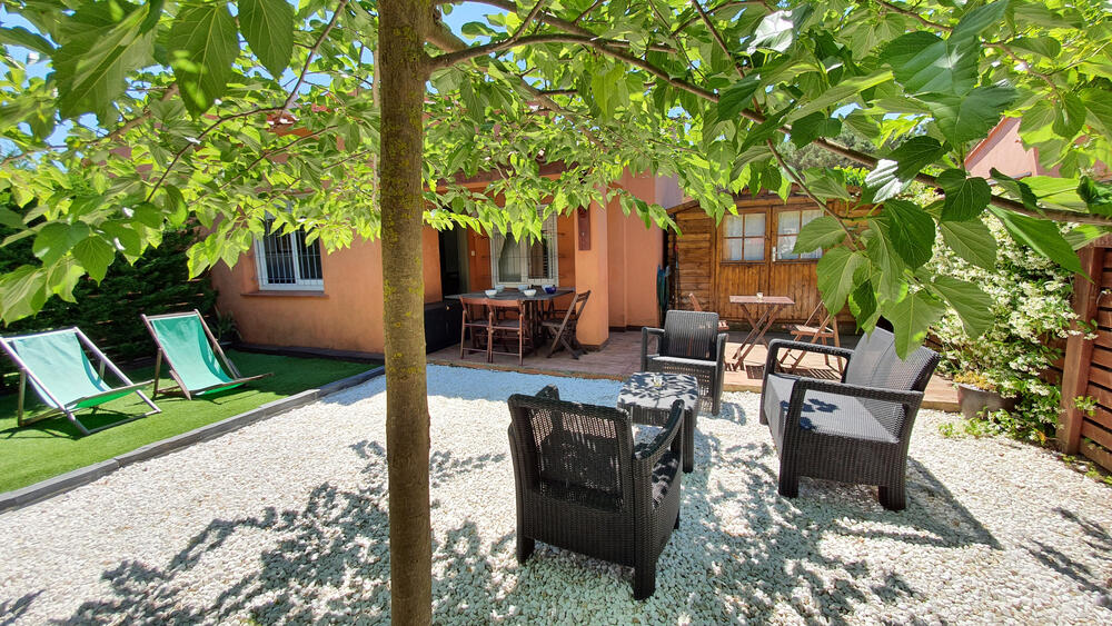 Garten mit Sonnenliegen, Gartenmöbeln und Grill